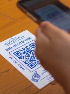 A person scanning a qr code with a cell phone.