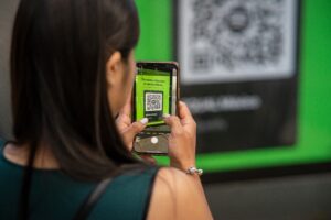 A woman is scanning a qr code on her phone.