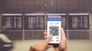 A person holding a smartphone displaying a qr code.