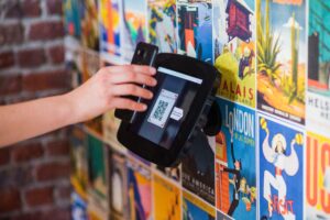 A person scanning a qr code on a wall using their phone.