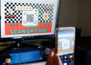 A person scanning a QR code on a computer screen.