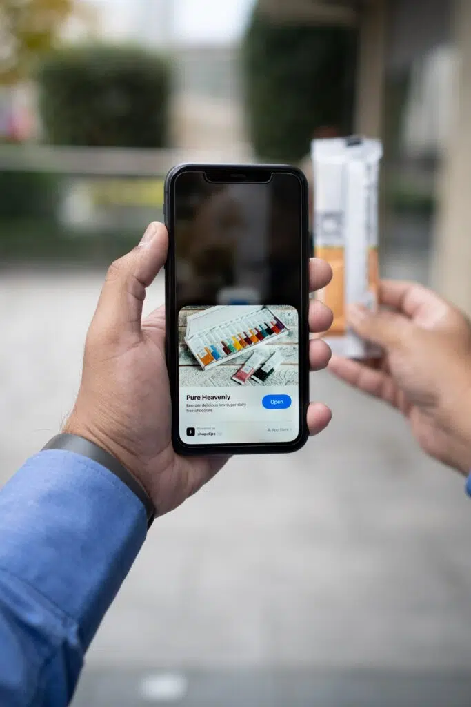 A man demonstrating a smartphone with a product image for creating effective landing pages.