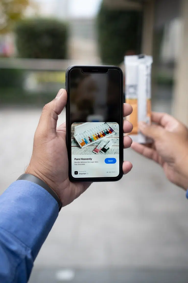 A man demonstrating a smartphone with a product image for creating effective landing pages.