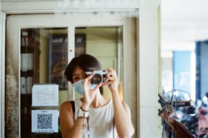 A woman streamlining property listings by taking a picture with a camera.