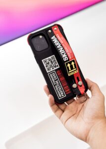 A person engaging consumers with a phone case featuring a QR code.