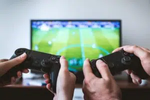 Two people gaming in front of a television.